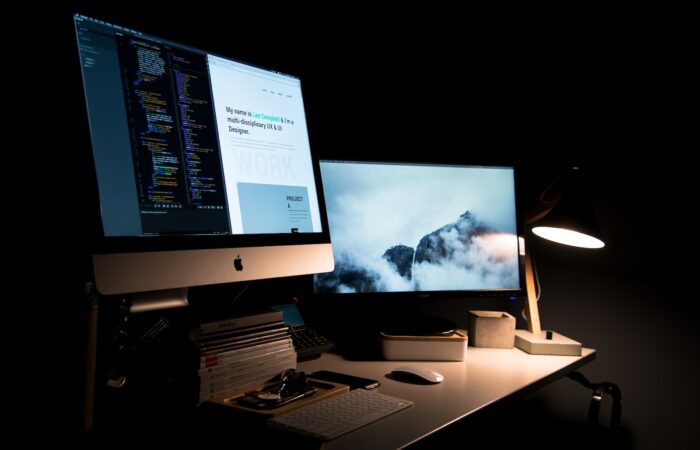 silver iMac turned on inside room